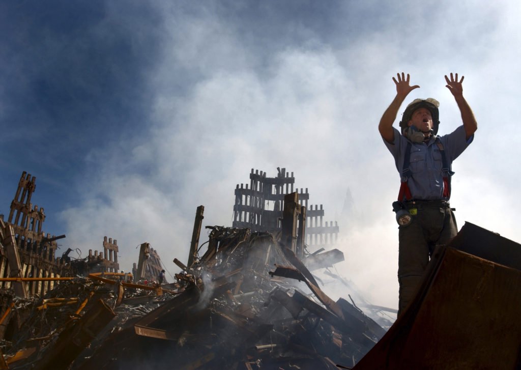 010915-N-3995K-015 New York, N.Y. (Sept. 15, 2001) -- A New York City fireman calls for 10 more rescue workers to make their way into the rubble of the World Trade Center. U.S. Navy Photo by Journalist 1st Class Preston Keres. (RELEASED)